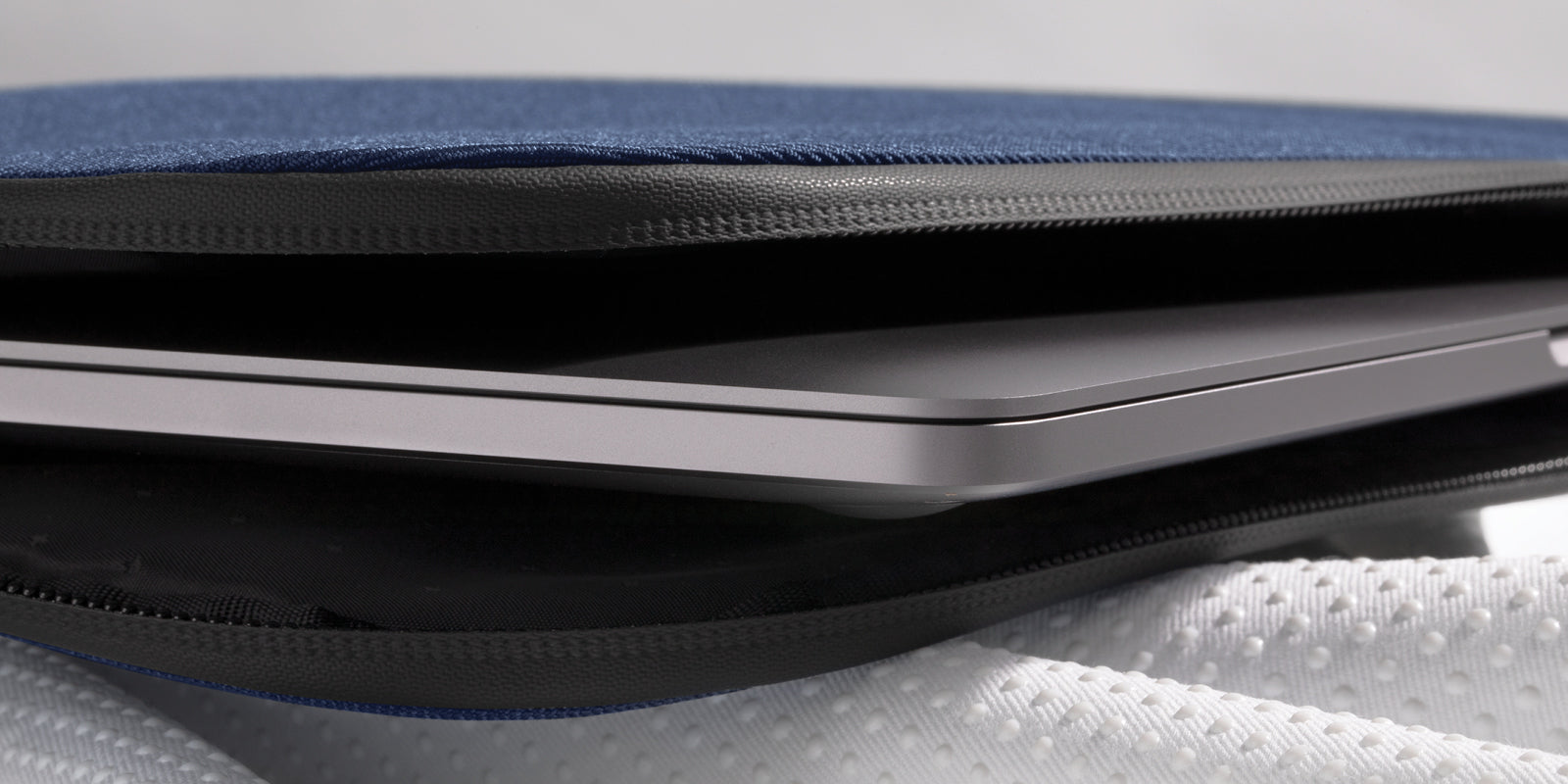 Soft interior padding protects against bumps and scrapes. Weather-resistant zipper keeps moisture out and your MacBook dry.