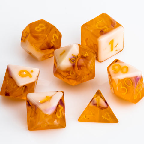 Orange and white rpg dice set on white background.