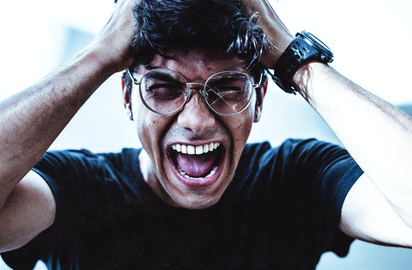 Frustrated man in black t-shirt and broken glasses. Courtesy of Yogendra Singh on Unsplash.com