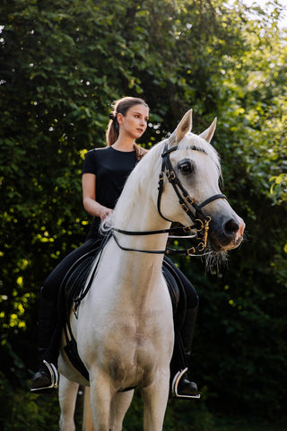 Dressage rider with safety stirrups on arabian horse