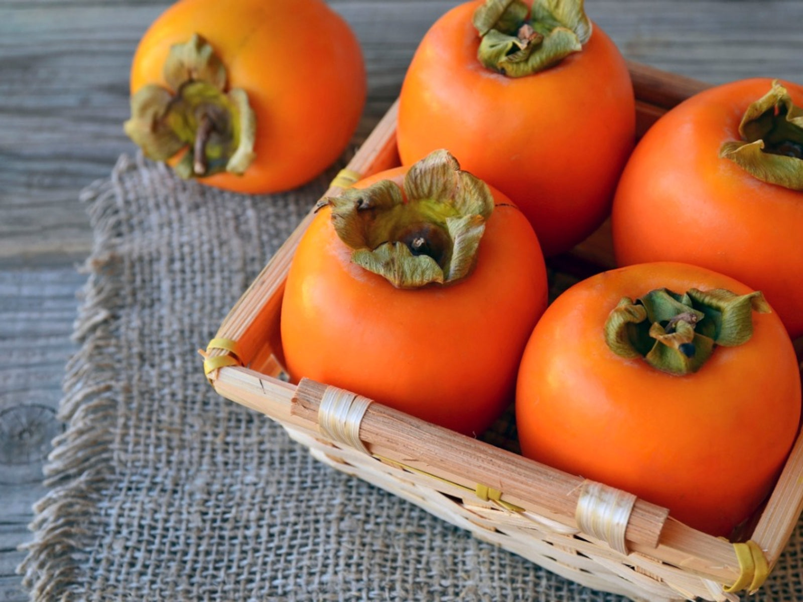 Persimmons in a basket for guinea pigs to eat