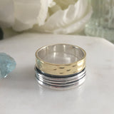 brass and silver spinner ring