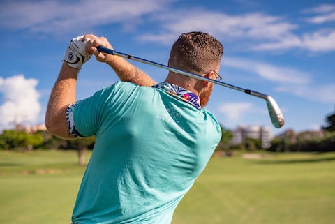 a man holding a golf club