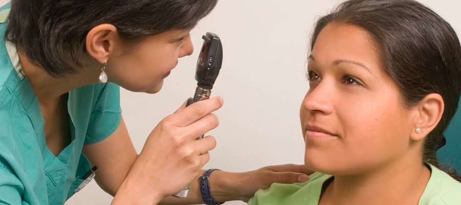 eye doctor perming exam on patient