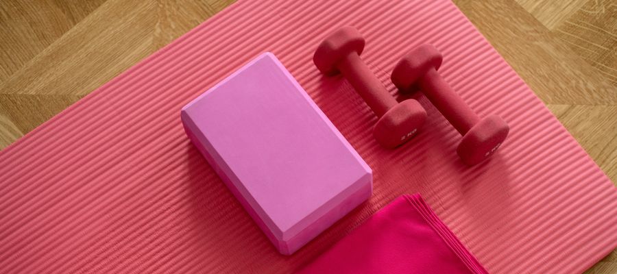 home exercise equipment on red yoga mat