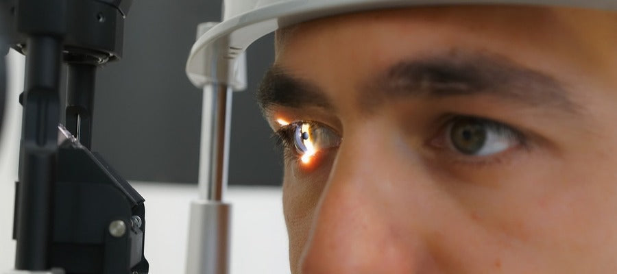 closeup of man's eyes undergoing eye examination