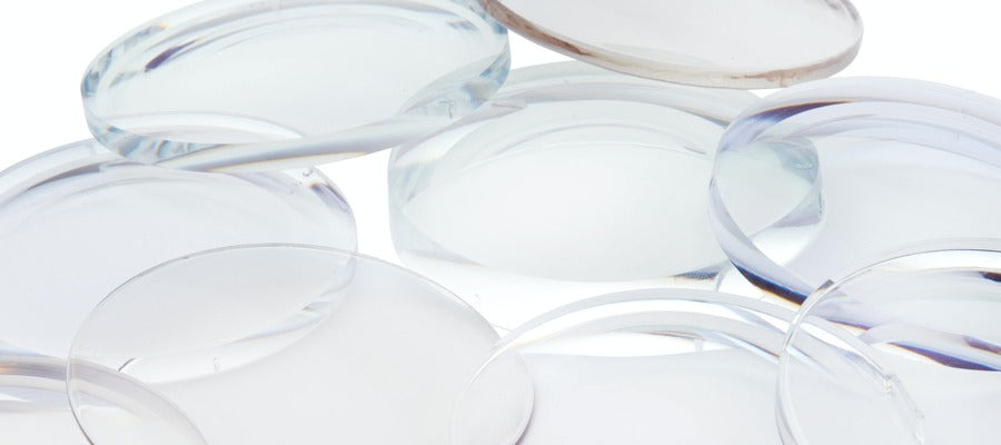 Primer plano de lentes de contacto esparcidas sobre la superficie blanca.