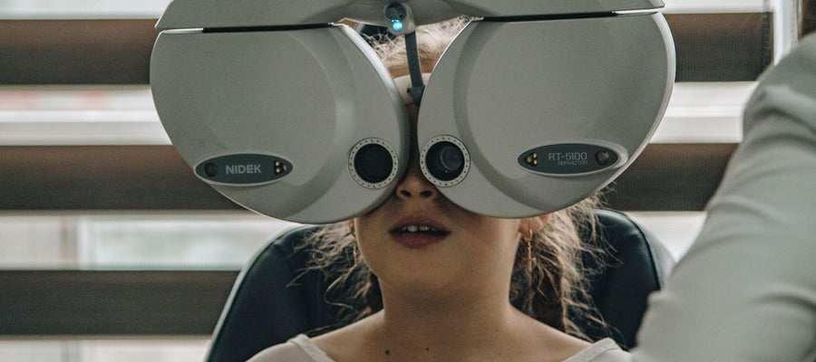 young girl undergoing eye exam