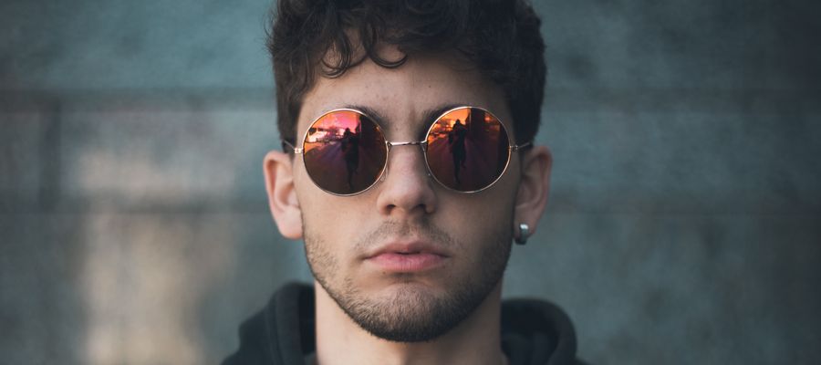 young man with piercing in his ear wearing sunglasses
