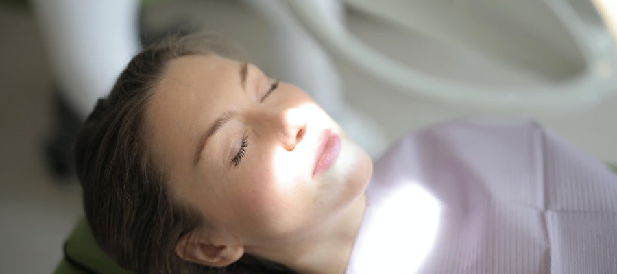 woman lying down in doctor's office about to undergo eye procedure