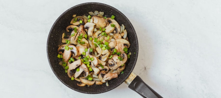 Mushrooms in a frying pan with leeks