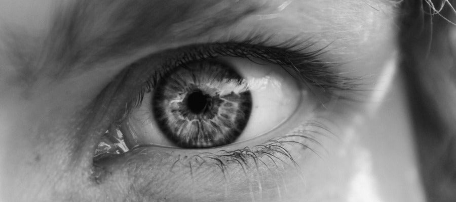 closeup of woman eye wide open in black and white