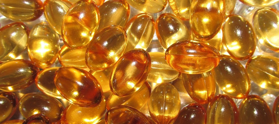 closeup of scattered vitamin E capsules seen from above