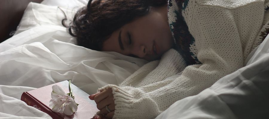 woman sleeping with book next to her