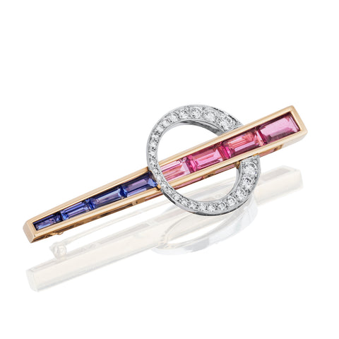 Bar pin featuring pink tourmalines and tanzanites totaling 4.96 carats accented with diamonds totaling 0.72 carat set in 14-karat gold by Jon Barry DiNola, Yardley Jewelers.