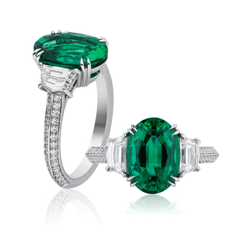Ring featuring a 3.38-carat oval-shaped emerald accented with diamond epaulets totaling 1.00 carat set in platinum by Niveet Nagpal, Omi Privé.