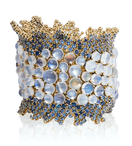 “Moon Dance” bracelet featuring rainbow, blue flash, silver flash and cat’s eye moonstones totaling 133.19 carats accented with sapphires totaling 38.61 carats set in 18-karat yellow gold by Paula Crevoshay, Mellika Company, Inc./Crevoshay.