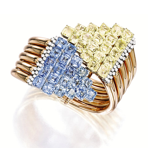 Retro-era hinged cuff bracelet featuring blue and yellow sapphires set in platinum and yellow gold