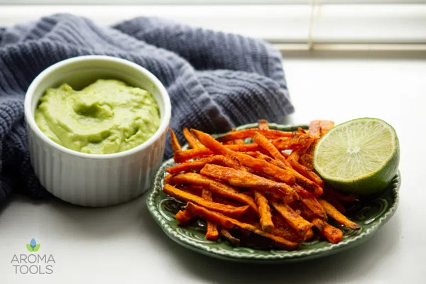 A serving of our Sweet Potato Fries with a small dish of homemade Avocado Coriander Dip. Recipes feature cassia, coriander and cumin essential oils. 