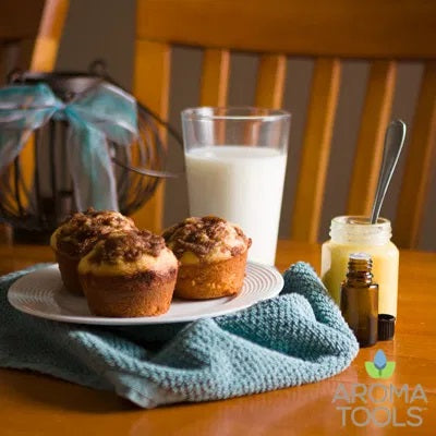 A plate with fresh cinnamon muffins, a glass of milk, and a 4 ounce jar of homemade lemon curd.