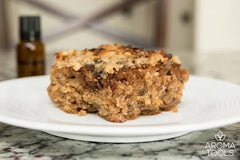 A slice of our Oatmeal Banana Spice Cake made with cinnamon essential oil on a plate sitting on a granite countertop.