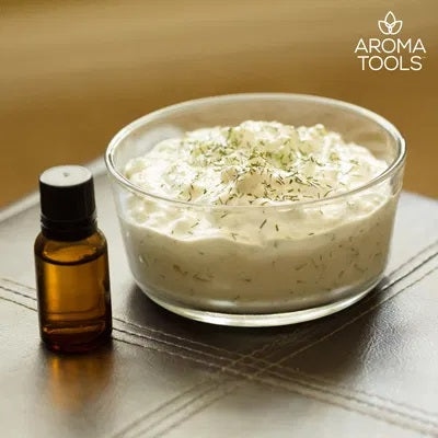 A glass bowl filled with homemade tzatziki sauce flavored with dill essential oil.