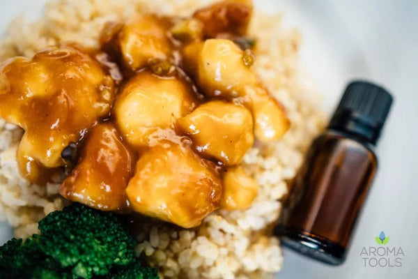 Chicken bites with a homemade orange and ginger essential oil glaze on a generous serving of brown rice and broccoli.