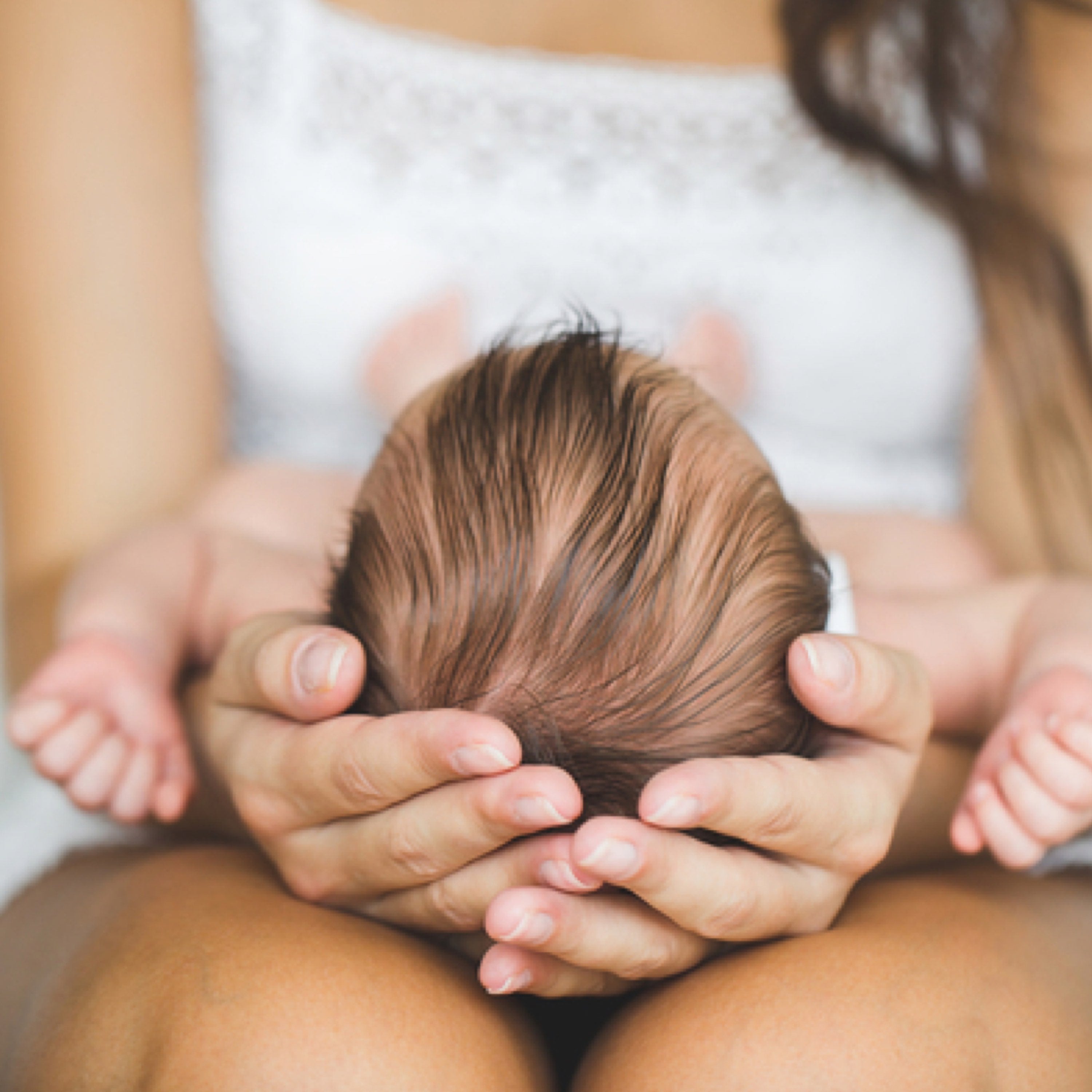 Baby laying on mothers lap