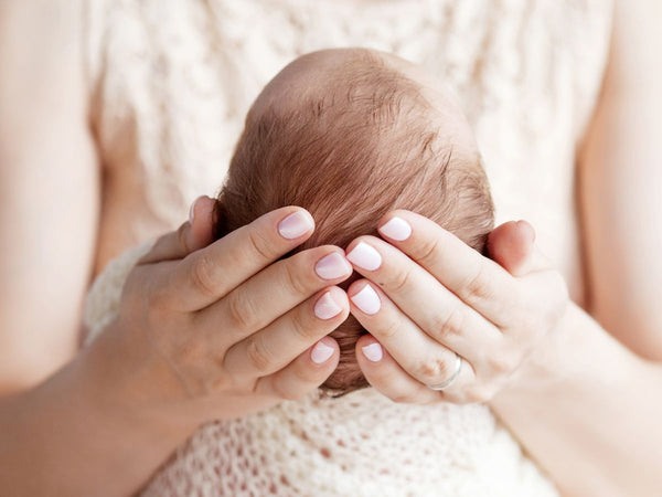 lady holding a baby's head