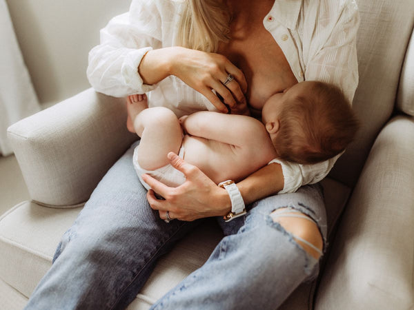 lady breastfeeding her child on a chair