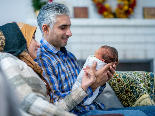 grandparents holding a newborn