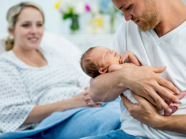 man holding a newborn baby