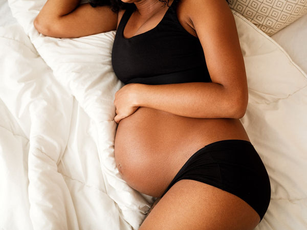 pregnant woman lying on her side