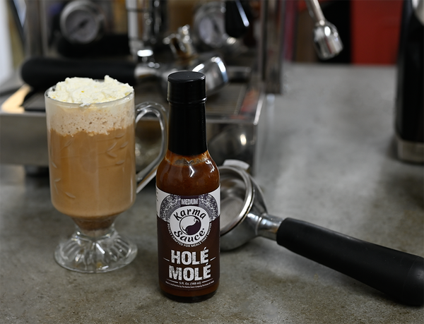 Hole Mole with mug of Irish Coffee and an espresso portafilter. Espresso machine is visible in background.