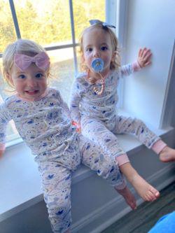 twin girls wearing magnetic me wonderland coveralls