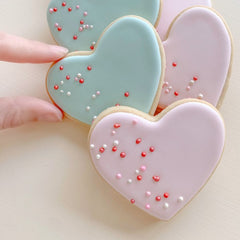 Heart shaped sugar cookies decorated in green and pink