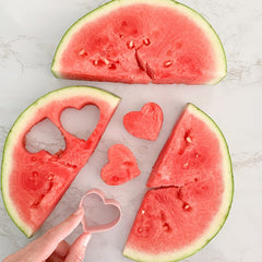 watermelon cut into heart shapes with cutter