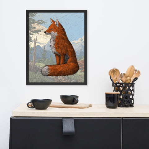 A framed print of a hand drawing red fox sitting in front of a faded background.  The print is hanging on a white wall above a counter with bowls, a coffee cup, and wooden spoons on the counter.