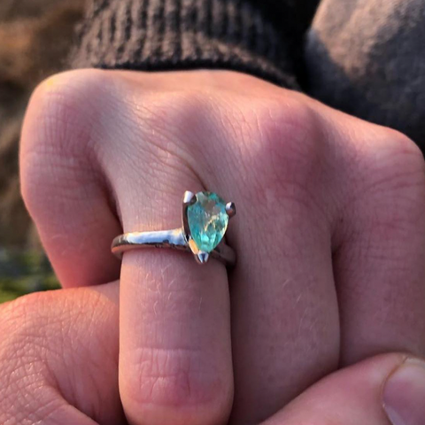 emerald ring on finger