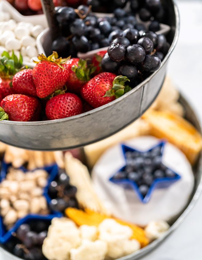 two tiered metal stand filled with fresh fruits