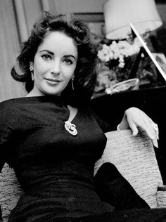 Liz Taylor wearing a brooch on her cleavage