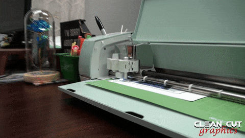 A Cricut machine is shown scanning the edges of the image printed on She Shed Vinyl's Inkjet Printable Heat Transfer Paper.