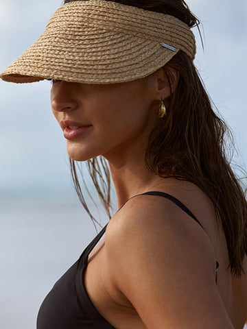 Woman wearing a visor with a black bikini top