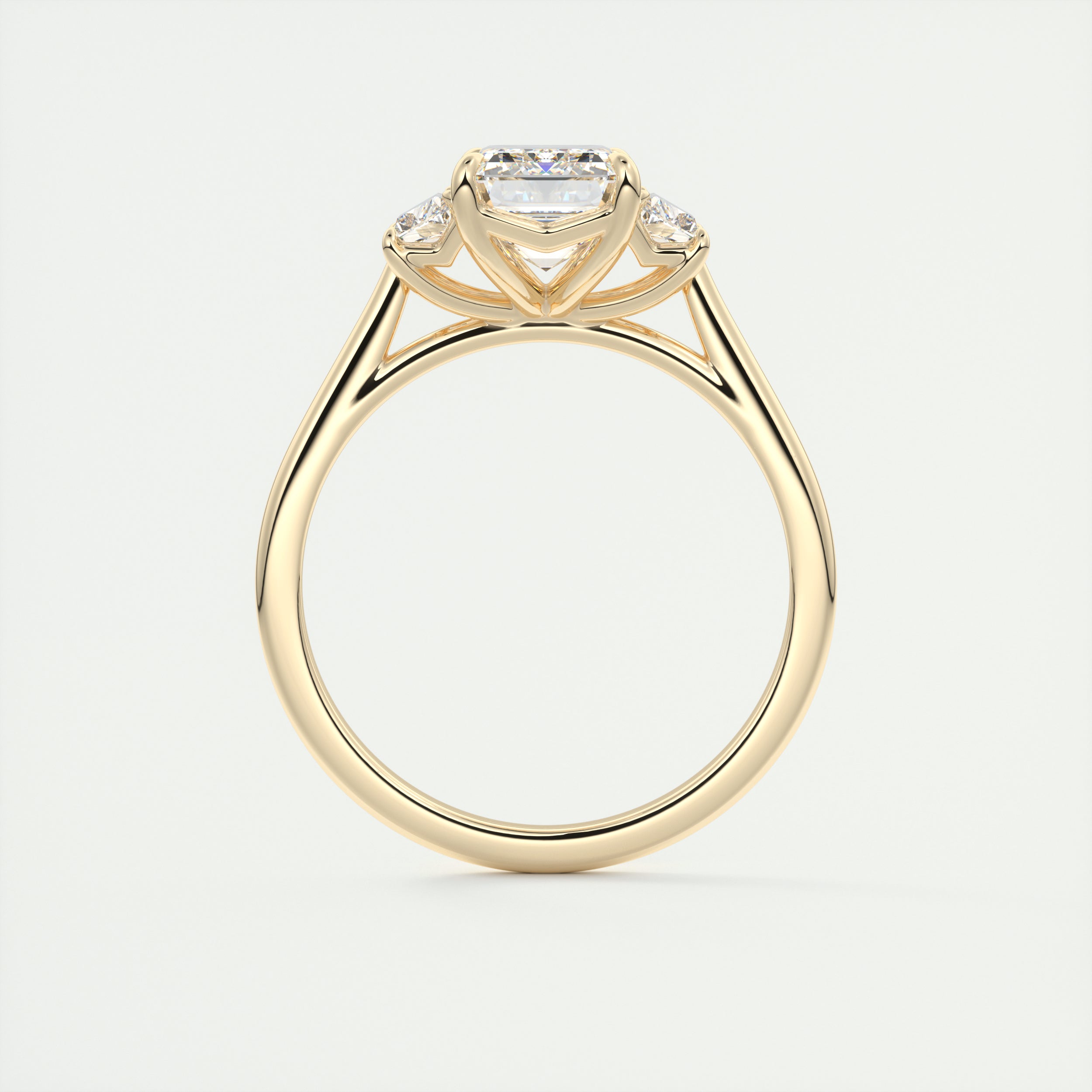 Emerald three stone Frank Darling diamond engagement ring with step cut trapezoid side stones in yellow gold