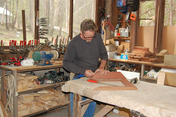 A handcrafted Jarrah wall clock by Chris Robbins from Western Australia, showcasing the natural beauty and warmth of the wood