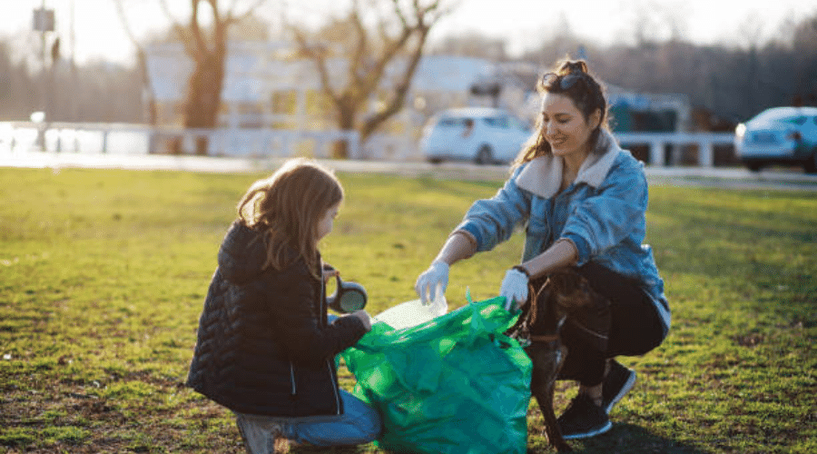 girl and woman picking up single-use plastic because kindness matters to animals