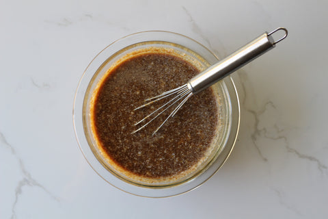 In a medium mixing bowl, combine the applesauce, flax eggs, coconut sugar, yacon syrup, coconut oil, almond milk, vanilla extract, and apple cider vinegar. Stir until well combined.