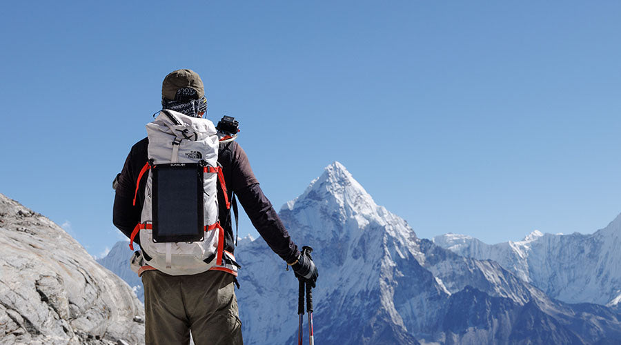 Men looking at a montain with a backpack and a Fusion flex 6 attached to it