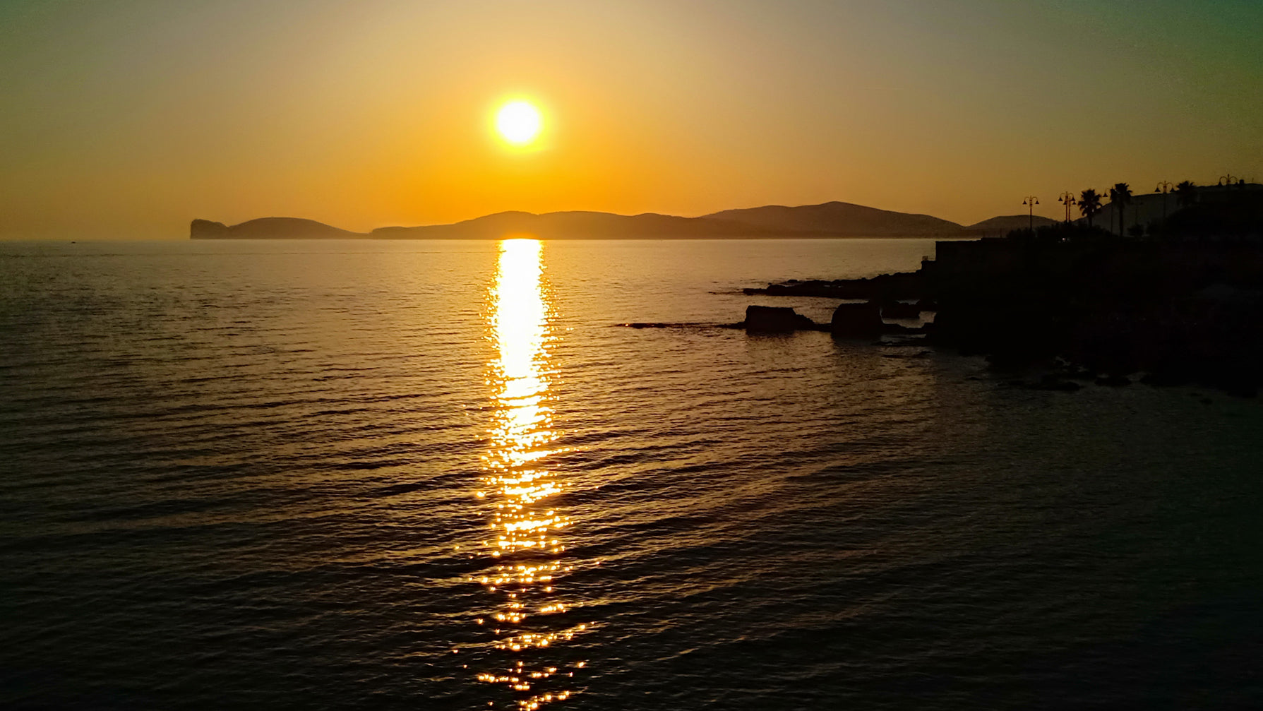 Capo Caccia sunset Alghero visit Sardinia travel holidays