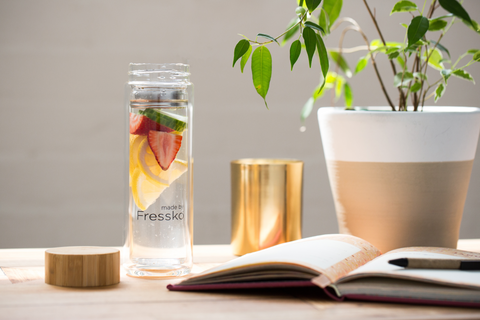 Made by Fressko glass infuser bottle with plant and book
